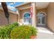 Inviting front entrance featuring well-maintained landscaping, a sitting bench, and elegant double doors at 8902 30Th E St, Parrish, FL 34219