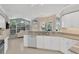 Modern kitchen open to living room and dining area with granite counters and stainless steel appliances at 8902 30Th E St, Parrish, FL 34219