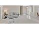Open-concept living room with a sofa, a side table, and a view of the front door at 8902 30Th E St, Parrish, FL 34219