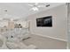 Open-concept living room with a large mounted TV and plush white sectional sofa at 8902 30Th E St, Parrish, FL 34219