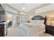 Bright primary bedroom featuring a king-size bed, and sliding glass doors leading to a private patio at 8902 30Th E St, Parrish, FL 34219