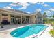 Sparkling pool with a screened-in patio area, surrounded by lush landscaping and a beautiful home at 8902 30Th E St, Parrish, FL 34219