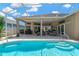Covered patio with outdoor seating, a grill, and access to the screened-in pool and backyard at 8902 30Th E St, Parrish, FL 34219