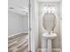 Cozy powder bath features a pedestal sink with brushed nickel fixtures and an oval mirror at 10407 Westpark Preserve Blvd, Tampa, FL 33625