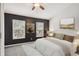 Bedroom featuring two windows, neutral carpeting, ceiling fan, and black accent wall at 10407 Westpark Preserve Blvd, Tampa, FL 33625