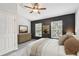 Bedroom featuring two windows, neutral carpeting, ceiling fan, and black accent wall at 10407 Westpark Preserve Blvd, Tampa, FL 33625