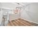 Bright dining area with wood-look flooring and modern light fixture, open to the kitchen at 10407 Westpark Preserve Blvd, Tampa, FL 33625