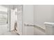 Hallway leading to a bedroom with a laundry closet featuring a stacked washer and dryer at 10407 Westpark Preserve Blvd, Tampa, FL 33625