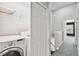 Hallway leading to a bedroom with a laundry closet featuring a side-by-side washer and dryer at 10407 Westpark Preserve Blvd, Tampa, FL 33625