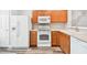 Functional kitchen features white appliances and wooden cabinets at 10407 Westpark Preserve Blvd, Tampa, FL 33625