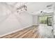 Spacious living room with wood-look floors, sliding glass doors, and ceiling fan at 10407 Westpark Preserve Blvd, Tampa, FL 33625