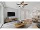 Open-concept living area with modern furnishings, TV, and dining space at 10407 Westpark Preserve Blvd, Tampa, FL 33625
