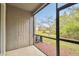 View from screened lanai out to lush lawn and mature trees, with door leading to the outside at 10407 Westpark Preserve Blvd, Tampa, FL 33625