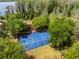 Overhead shot of a well-maintained basketball court surrounded by lush greenery at 11534 Biddeford Pl, New Port Richey, FL 34654