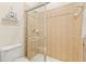 Bathroom featuring a tile shower with glass door and a modern toilet at 11534 Biddeford Pl, New Port Richey, FL 34654