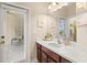 Bathroom featuring vanity with sink, wall decorations, and door to outside at 11534 Biddeford Pl, New Port Richey, FL 34654