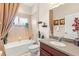 Cozy bathroom with tub/shower combo, tile walls and floors, and vanity at 11534 Biddeford Pl, New Port Richey, FL 34654