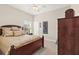Comfortable bedroom with a ceiling fan, a picture frame collage and a beautiful wooden dresser at 11534 Biddeford Pl, New Port Richey, FL 34654