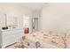 Bedroom with white dresser and view of the bathroom through an open door at 11534 Biddeford Pl, New Port Richey, FL 34654