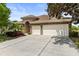 Stunning exterior with stone accents, a two-car garage, and a pristine driveway under a blue sky at 11534 Biddeford Pl, New Port Richey, FL 34654