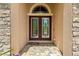 Elegant front door with decorative glass and stone accents, creating a welcoming entrance at 11534 Biddeford Pl, New Port Richey, FL 34654