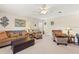 Inviting upstairs living room with sofa, chairs, ottoman, and decorative lighting at 11534 Biddeford Pl, New Port Richey, FL 34654