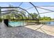 The screened-in pool area has a safety fence, a hot tub, and a view of the water at 11534 Biddeford Pl, New Port Richey, FL 34654