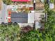 Aerial view of a home highlighting its varied roof sections, mature trees, and surrounding structures at 1209 E 29Th Ave, Tampa, FL 33605