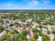 Property overhead shot of neighborhood and a nearby pond, and mature trees at 1209 E 29Th Ave, Tampa, FL 33605