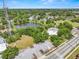 An aerial view shows the property near a large pond with green scenery, and a convenient parking lot at 1209 E 29Th Ave, Tampa, FL 33605