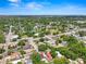Overhead shot of property in quiet neighborhood featuring a nearby pond, and mature trees at 1209 E 29Th Ave, Tampa, FL 33605
