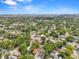 An aerial view shows the property nestled within a lush, tree-lined neighborhood close to the downtown area at 1209 E 29Th Ave, Tampa, FL 33605