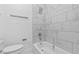 Bright bathroom with a shower-tub combo and marble-style tiling at 1209 E 29Th Ave, Tampa, FL 33605