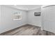 Light filled bedroom featuring wood-look floors, white walls and a closet at 1209 E 29Th Ave, Tampa, FL 33605