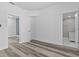 This neutral bedroom has modern flooring, recessed lights, closet and doors to the bathroom and hallway at 1209 E 29Th Ave, Tampa, FL 33605