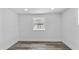 Bright bedroom featuring grey vinyl floors, white walls, recessed lighting, and a large window at 1209 E 29Th Ave, Tampa, FL 33605