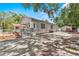 Charming home exterior with gray paint, white trim, and stone accents with a fenced yard at 1209 E 29Th Ave, Tampa, FL 33605
