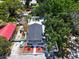 An aerial view showcases the front of the home with a well-maintained lawn and convenient parking at 1209 E 29Th Ave, Tampa, FL 33605