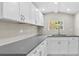 Bright kitchen with white cabinetry and dark countertops at 1209 E 29Th Ave, Tampa, FL 33605