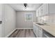 Bright eat-in kitchen featuring white cabinets, double sink, and window offering lots of natural light at 1209 E 29Th Ave, Tampa, FL 33605
