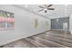 An open-concept living room with sleek wood-look flooring, recessed lighting, and neutral color palette at 1209 E 29Th Ave, Tampa, FL 33605