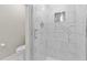 Modern bathroom shower with white marble-style tiles and glass door at 1209 E 29Th Ave, Tampa, FL 33605