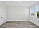 Bright bedroom features gray flooring and natural light streaming in from the energy-efficient windows at 12156 Cattleside Dr, Riverview, FL 33579