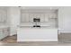Modern kitchen features white cabinets, stainless steel appliances, large island, and ample countertop space at 12156 Cattleside Dr, Riverview, FL 33579