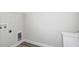 Laundry room with washer/dryer hookups, sink and vinyl wood floors at 12156 Cattleside Dr, Riverview, FL 33579