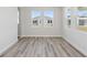 Bright living room with natural light, featuring sleek gray flooring and a view to the home next door at 12156 Cattleside Dr, Riverview, FL 33579
