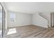 Bright living room area features modern gray flooring and sliding door access to the outside at 12156 Cattleside Dr, Riverview, FL 33579
