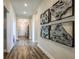Hallway featuring hard wood floors and decorative artwork at 12158 Cattleside Dr, Riverview, FL 33579