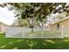 Lovely backyard featuring a white picket fence creating a secure and picturesque outdoor space at 12506 Safari Ln, Riverview, FL 33579