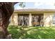 Backyard view highlighting the lush green grass and screened in porch and exterior of the home at 12506 Safari Ln, Riverview, FL 33579